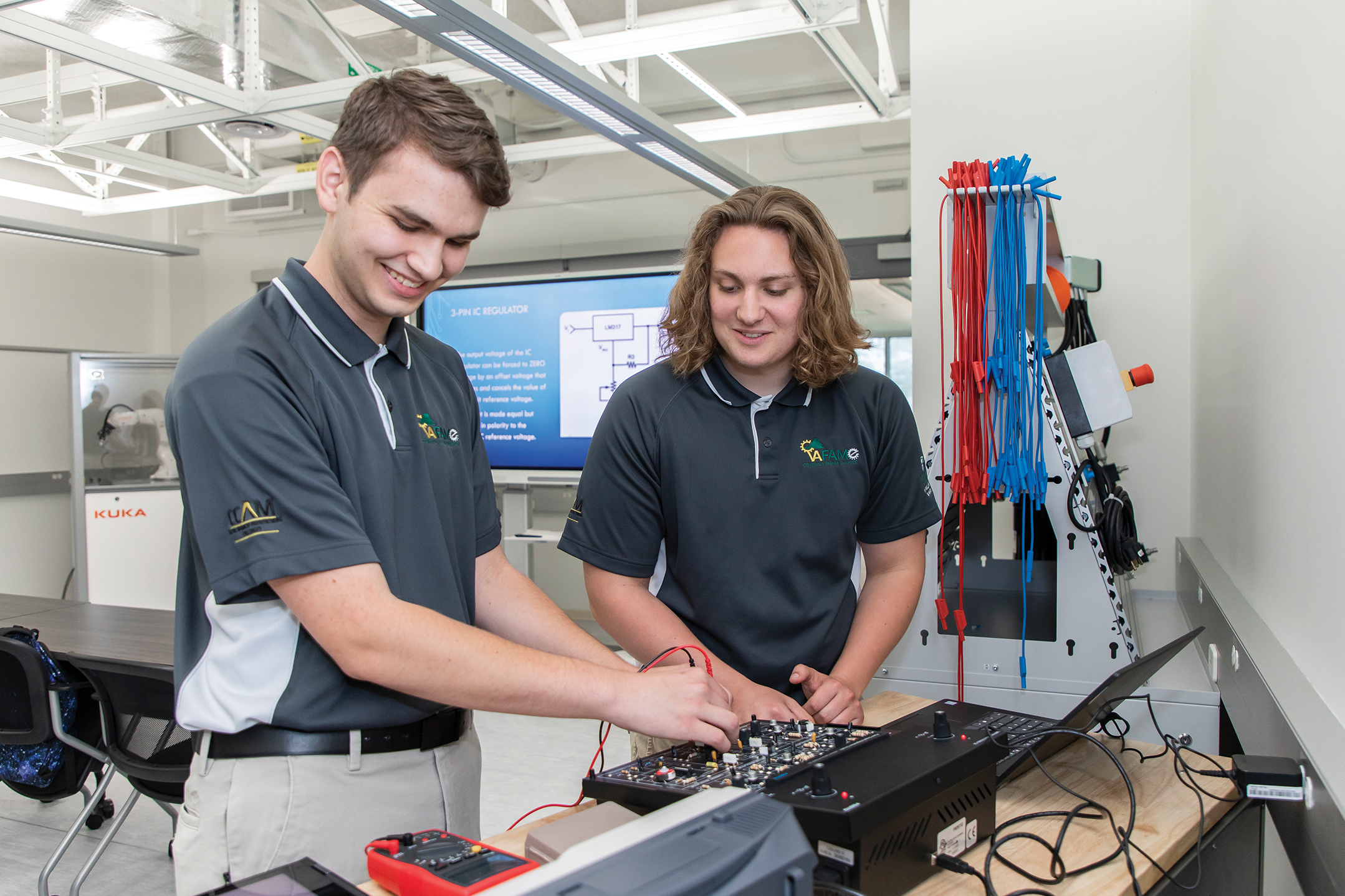 Two men working on electric equipment