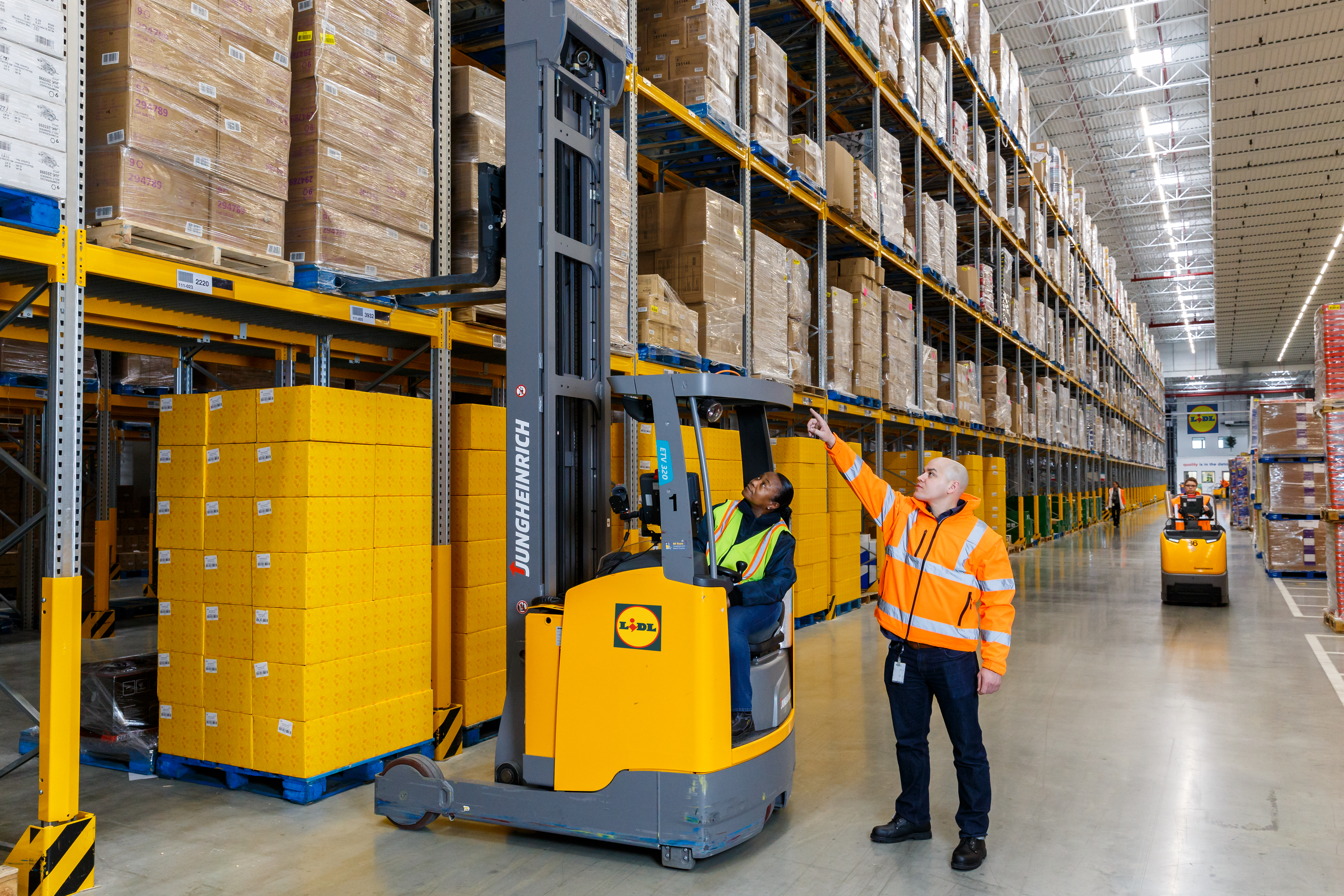 A man and a forklift in a warehouse