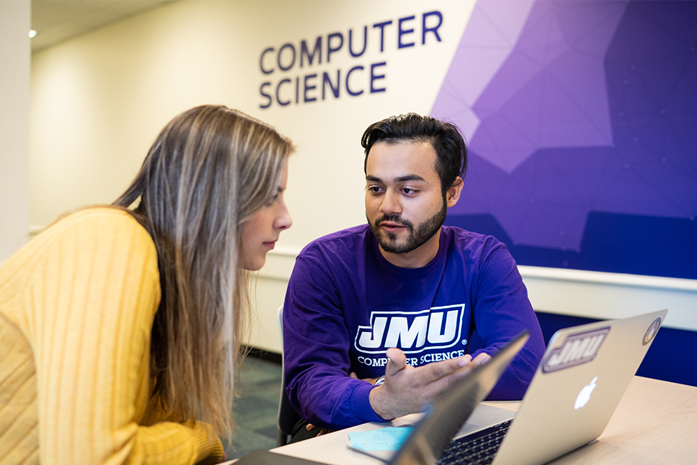 Male and Female student working on computers in a computer science classroom at James Madison University