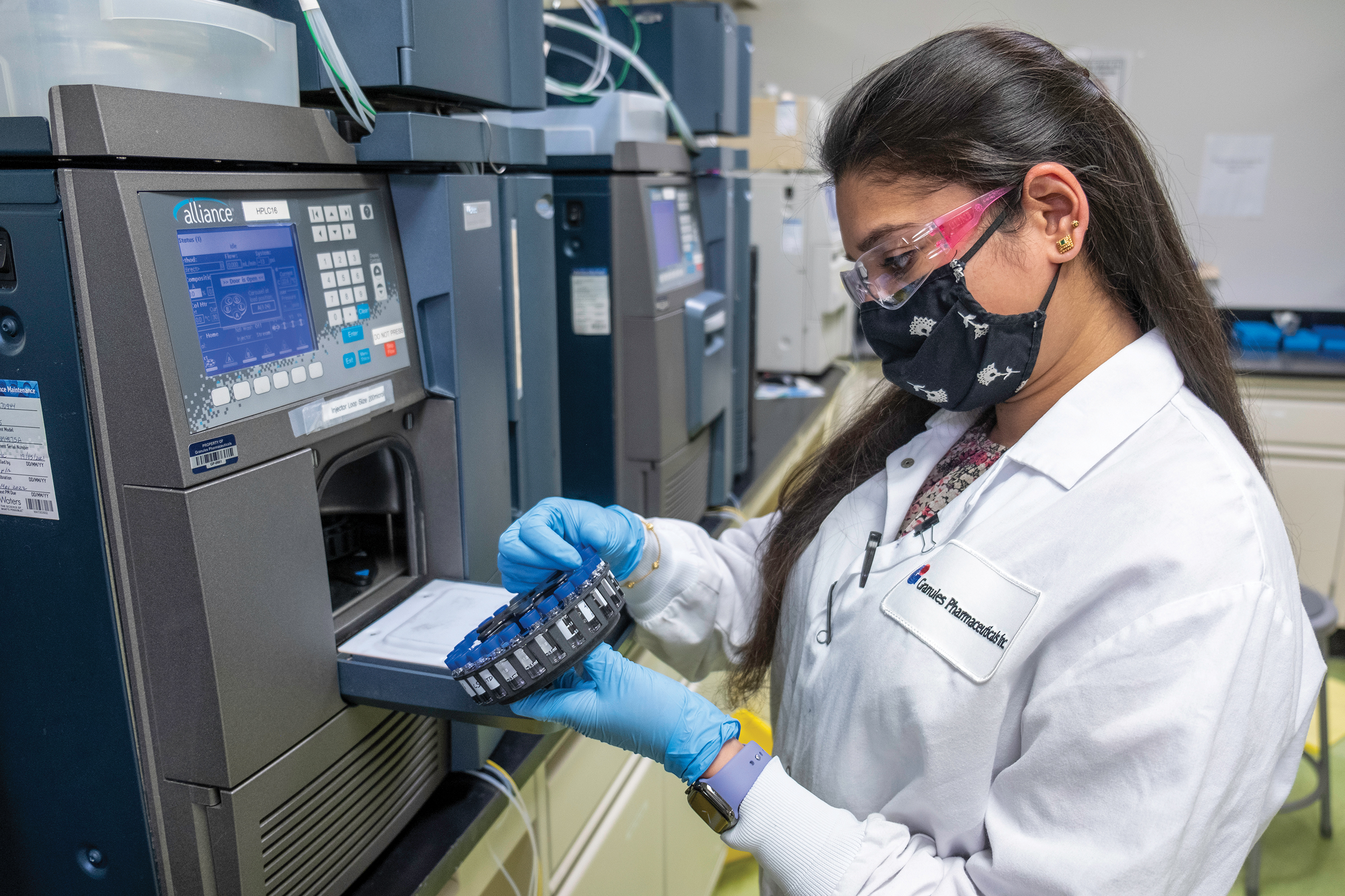 A woman in a lab coat working on generic drug testing 