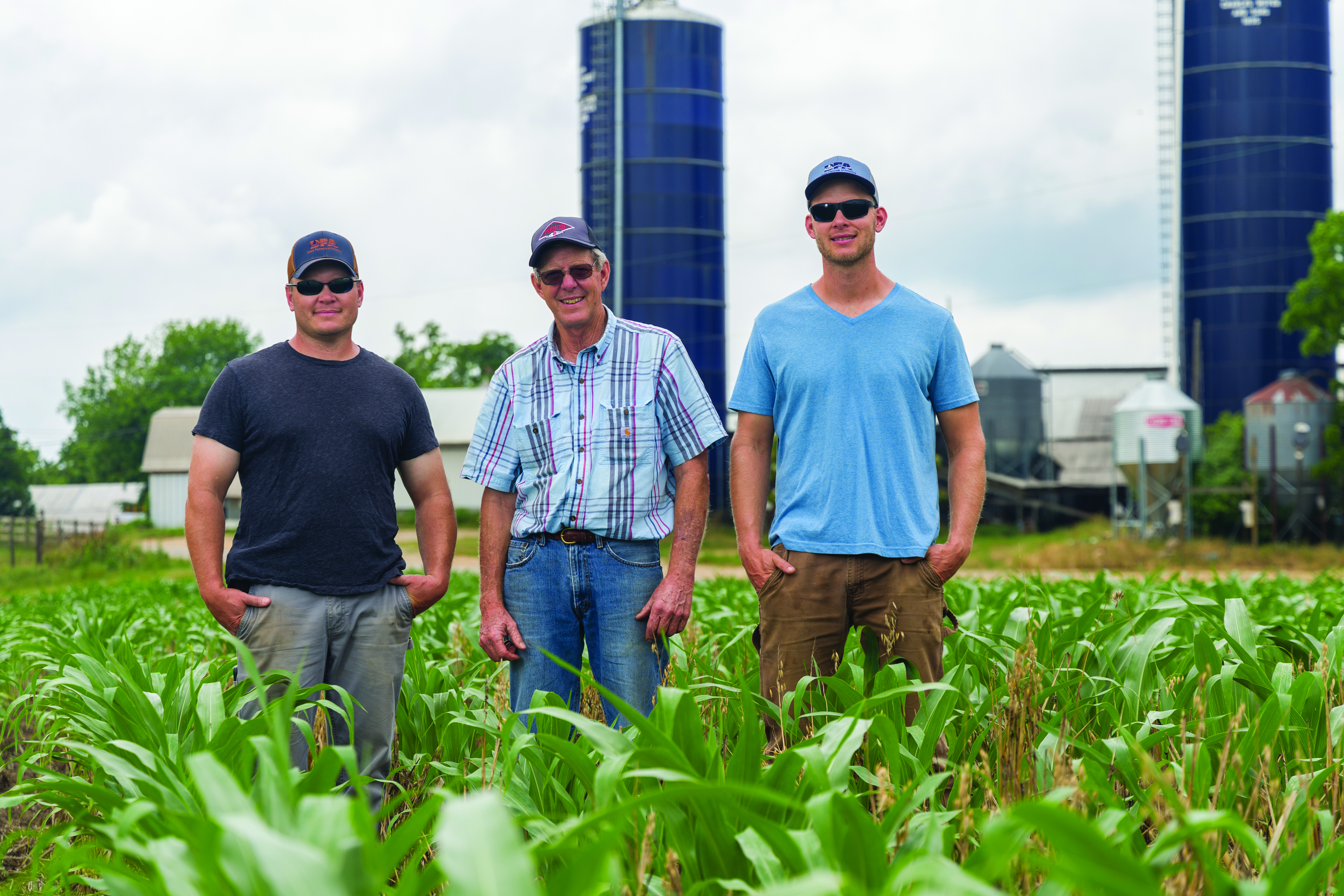 Three men standing in a field at Oakmulgee Dairy Farm