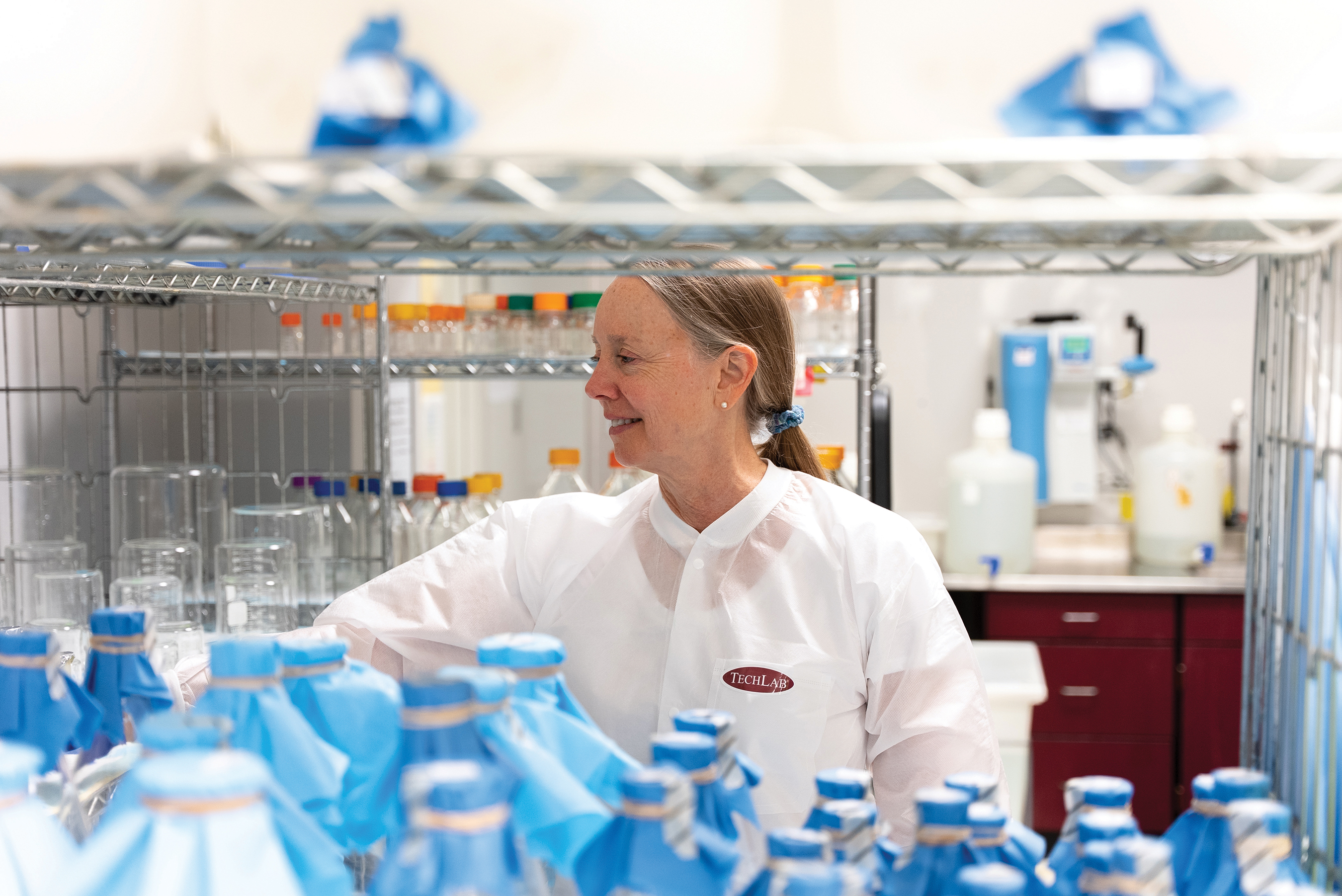 A TECHLAB employee in a lab coat 