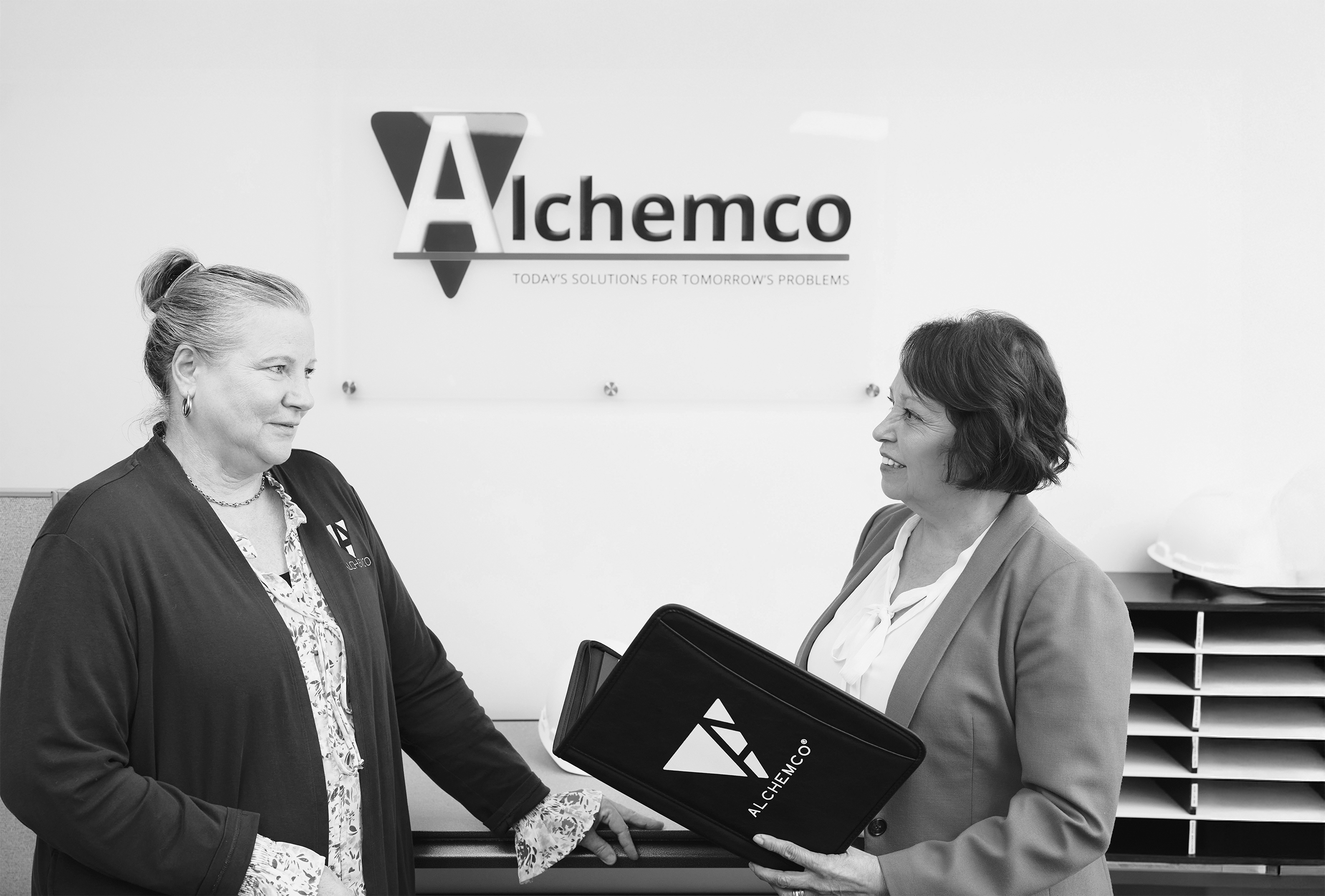 Two individuals meeting at Alchemo, Inc.