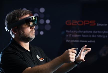 A man wearing virtual reality glasses and controlling a computer remotely
