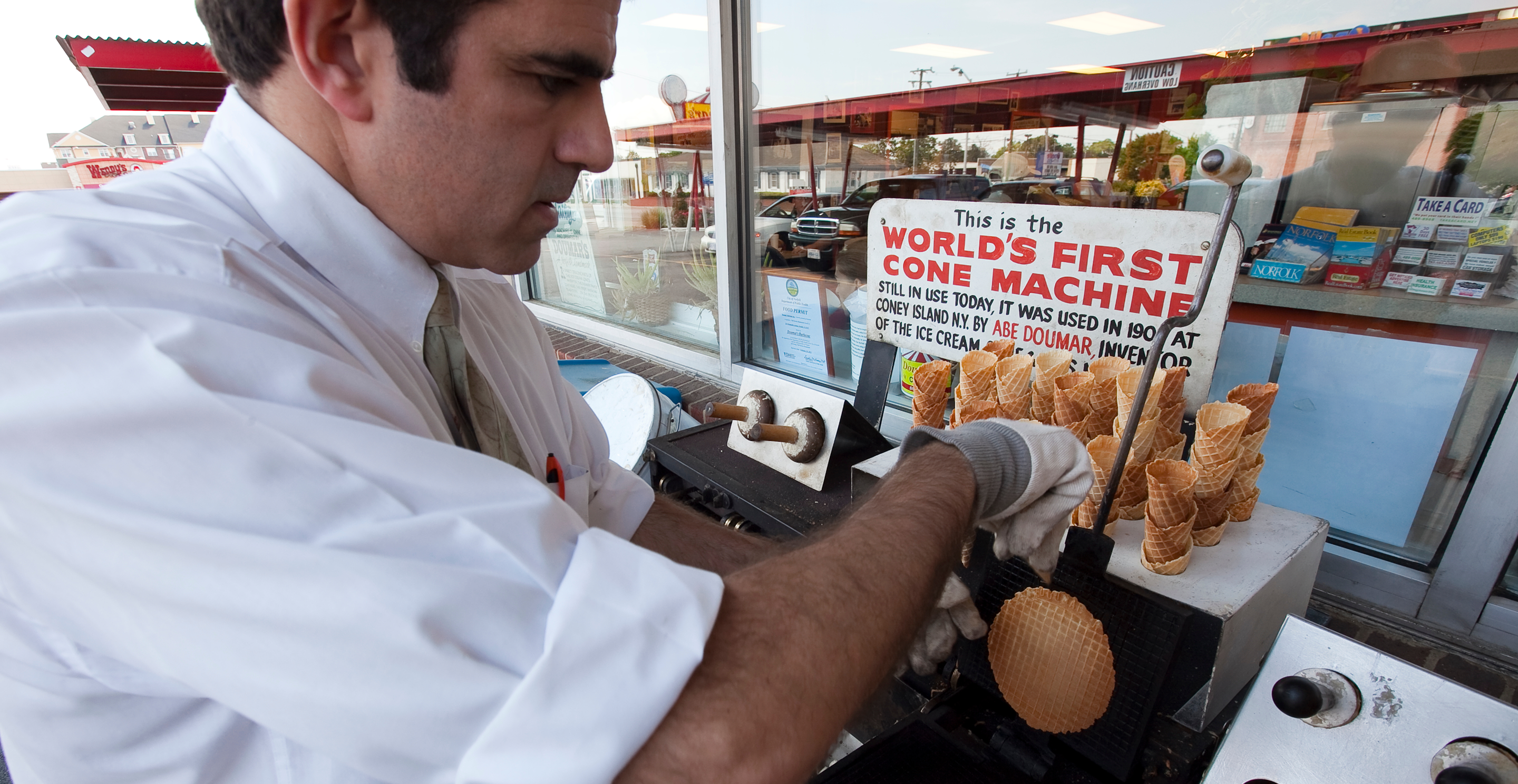 Man making waffle cones at an ice cream stand