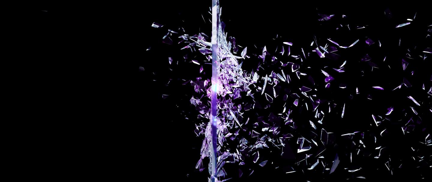 A black image of purple glass shattering 