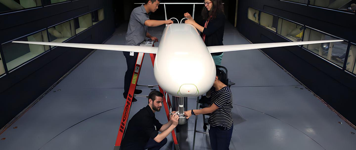 Four people working on a plane to support the NASA Langley partnership