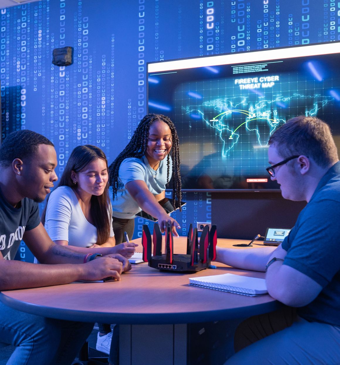 4 ODU School of Cybersecurity Students sitting around a table