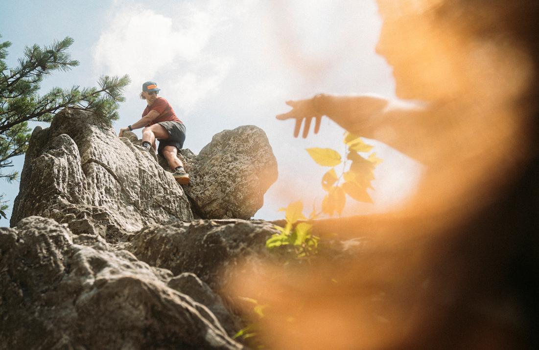 Hiker climbing across a rocky outcrop