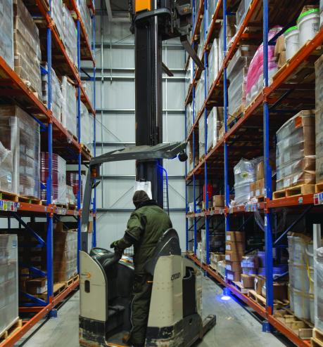 A man operating a forklift in a warehouse