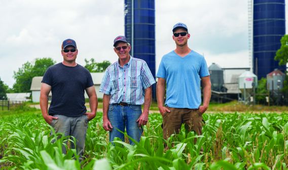 Three men standing in a field at Oakmulgee Dairy Farm