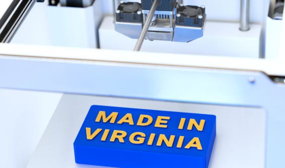 A 3D printer makes a sign that reads "Made in Virginia."