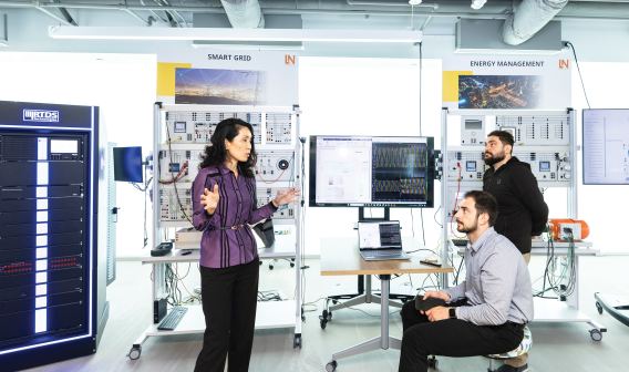 Three people in the Smart Grid lab at George Mason University