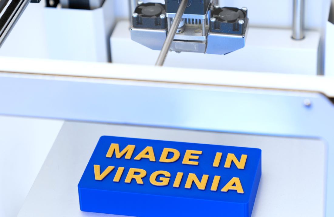 A 3D printer makes a sign that reads "Made in Virginia."