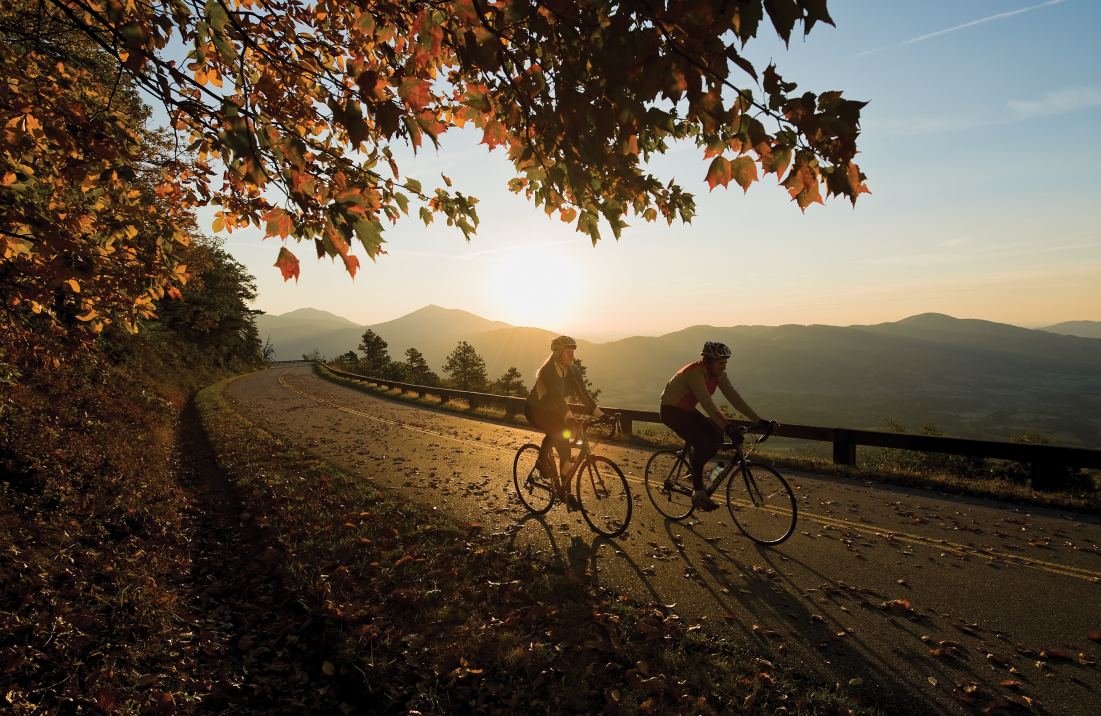 Two cyclists ride on a road in Virginia's Blue Ridge Mountains