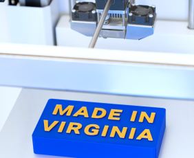 A 3D printer makes a sign that reads "Made in Virginia."