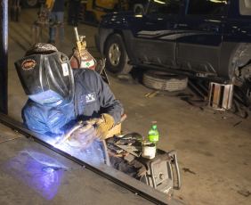 Photo of a man using a welding tool
